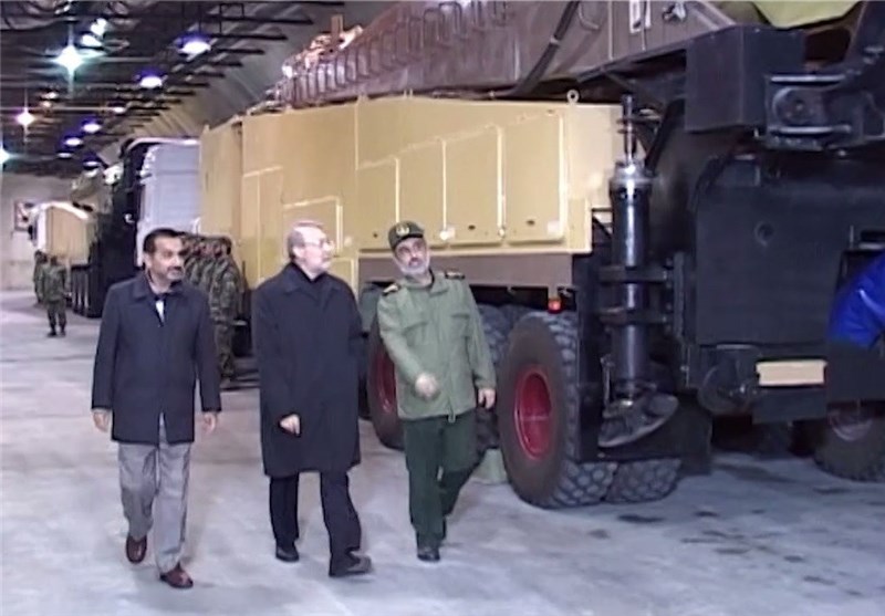 Ali Larijani walks with IRGC officers past missile transporter trucks inside a tunnel